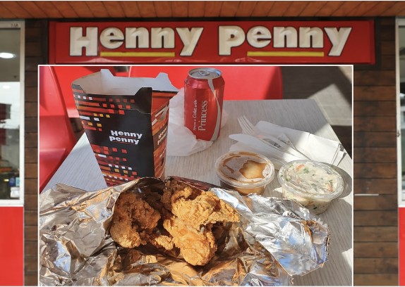 A Henny Penny chicken feed spread out on foil beneath the shopfront sign.
